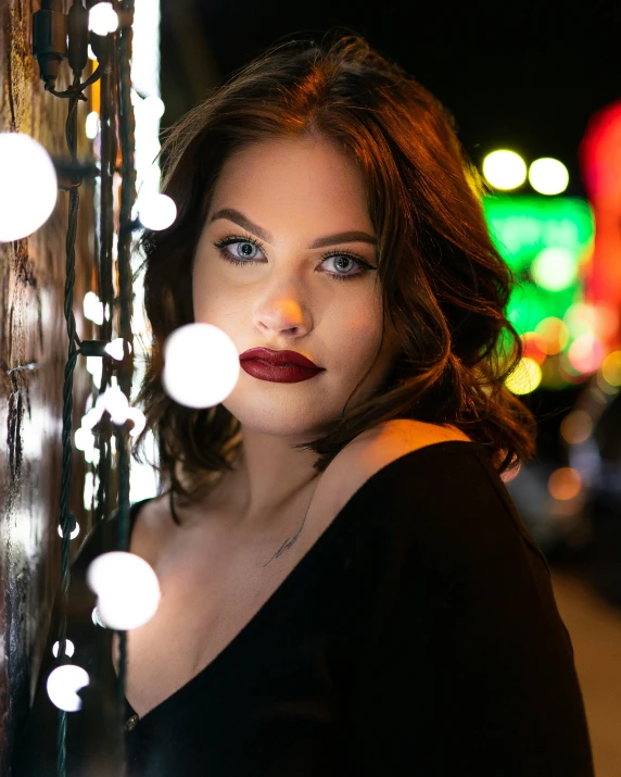 a woman with her face tilted in front of some lights