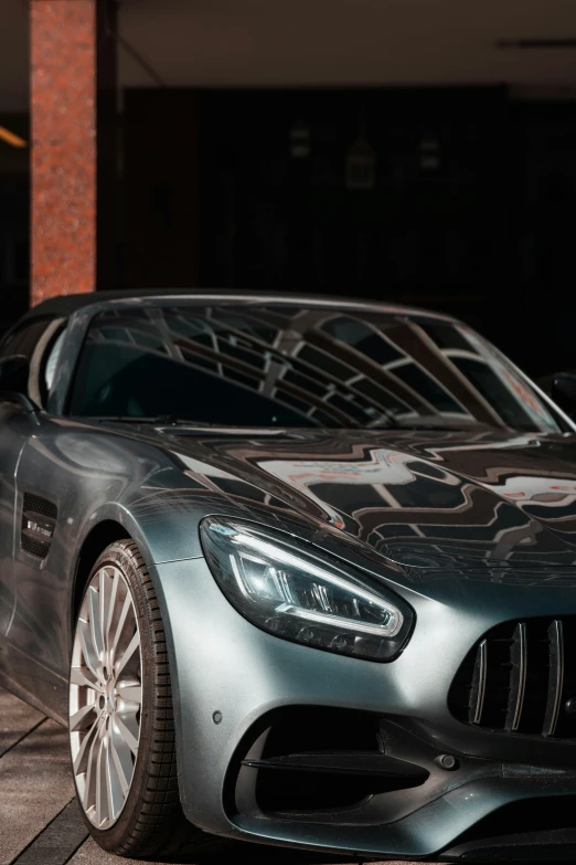 the mercedes - amg gt has a hood covered in smoke