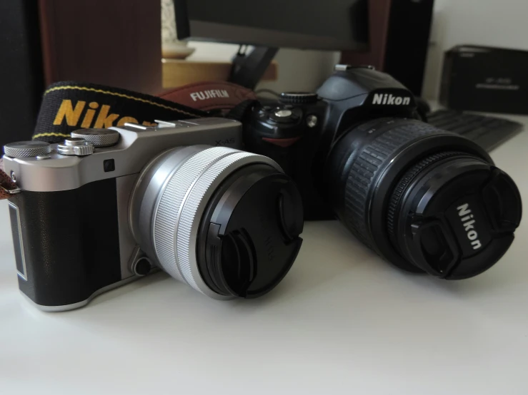 a couple of cameras sit on top of a table