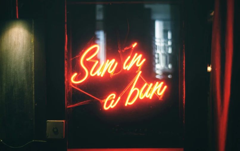 a neon sign is displayed in the front of a building
