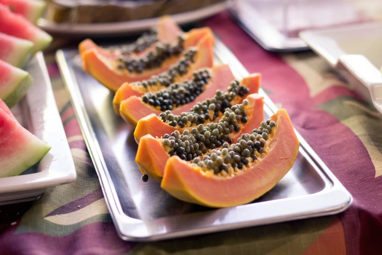 fruit on serving trays with spoon and knife