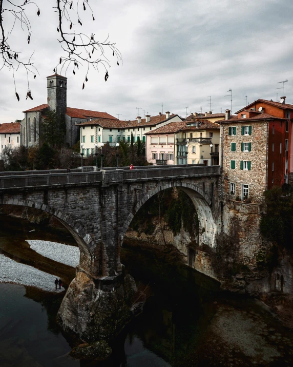 old bridge in middle of town with buildings