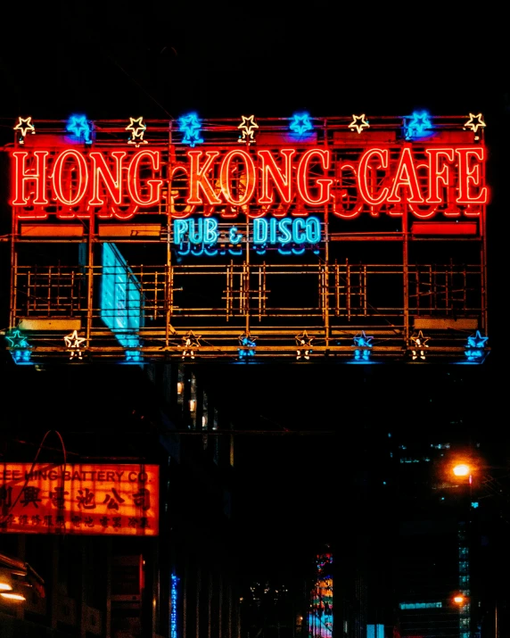 lighted signage above sidewalk at night time