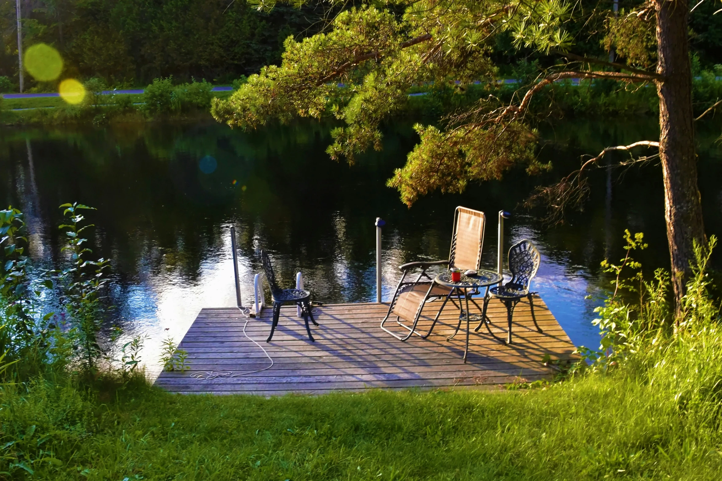 a dock that has two lawn chairs on it