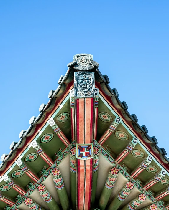 a clock is sitting at the top of an ornate roof