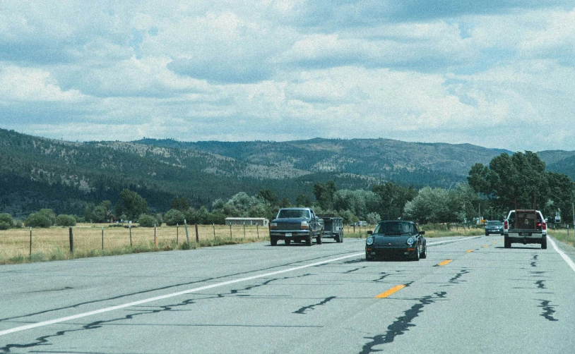 cars traveling down the highway on a cloudy day