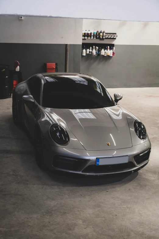 a grey sports car sits in a room