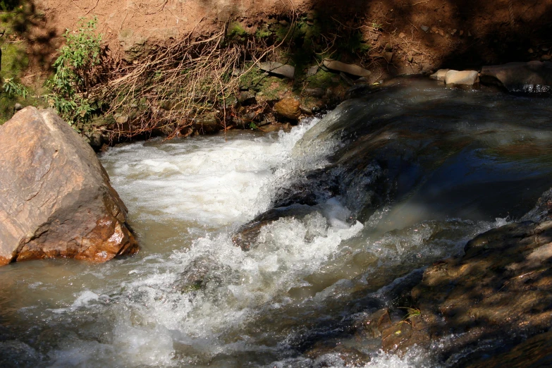 a big rock in the middle of a stream