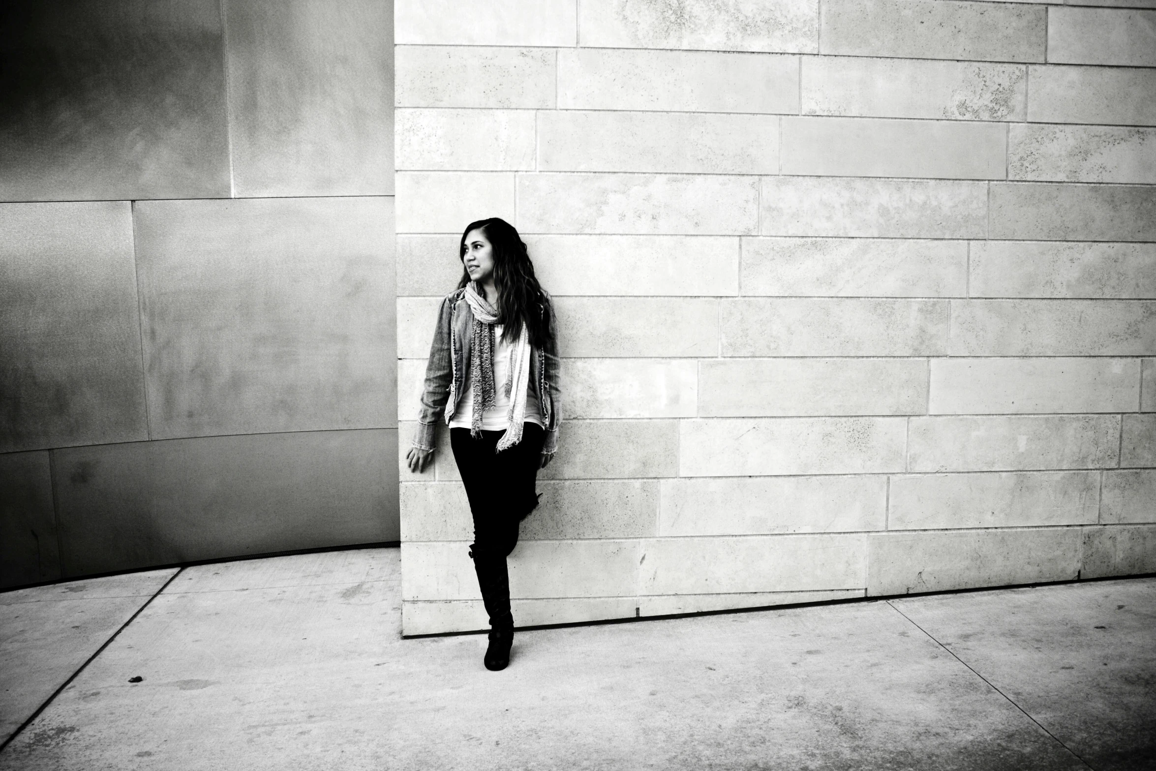 a black and white po of a woman leaning against a wall