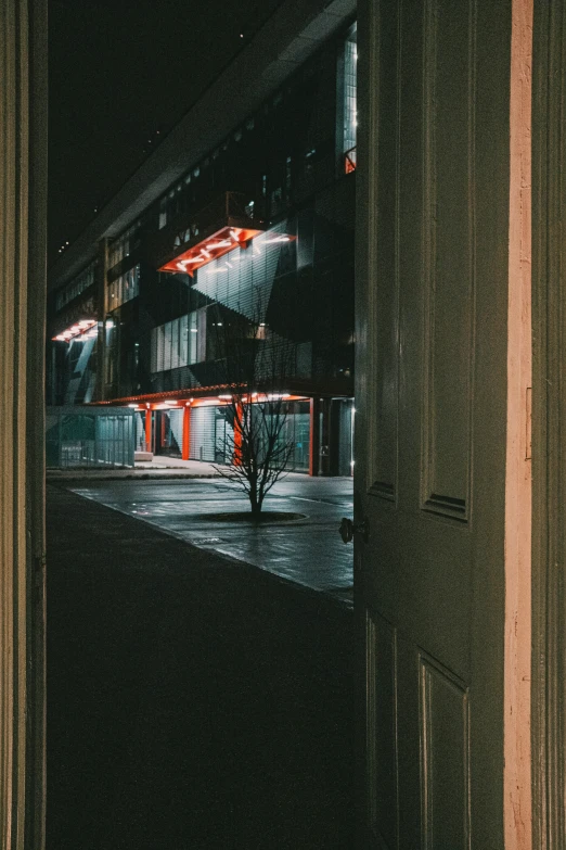 a dark, empty courtyard with the building lit up in lights