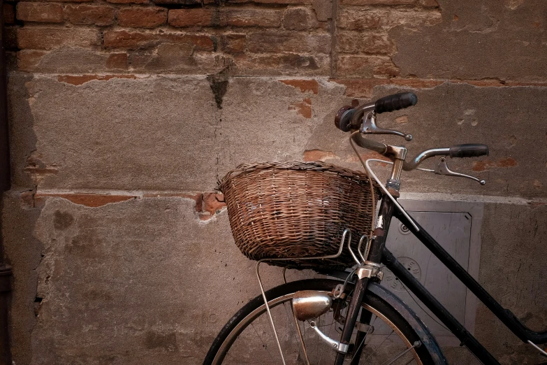 the bicycle is  to the brick wall