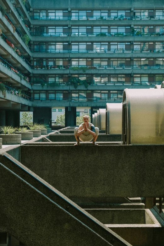 two people in front of some large, curved concrete structures