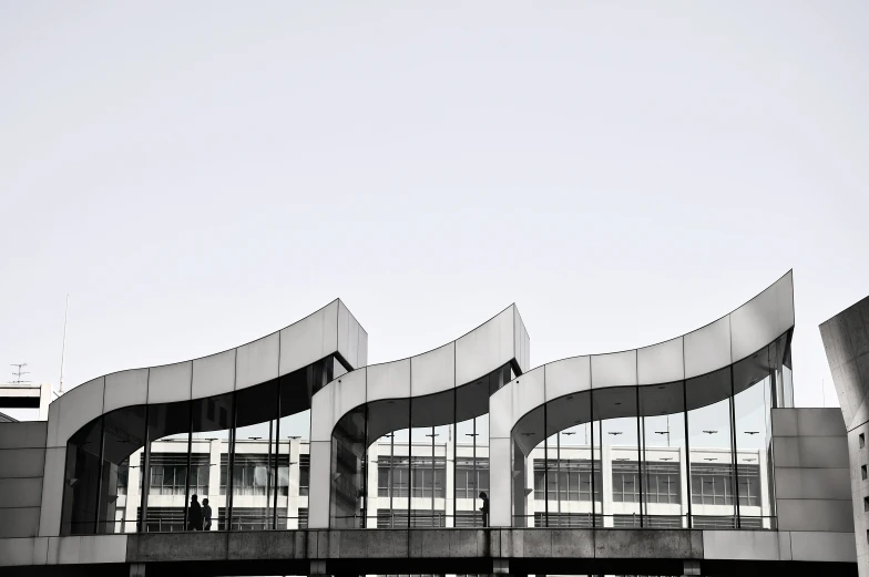 an artistic building has unusual curved glass windows