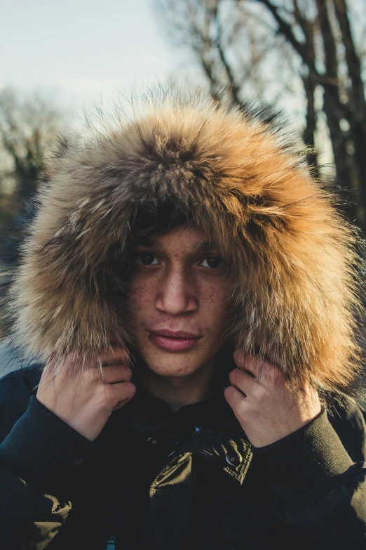 man in black coat posing for a picture with fur