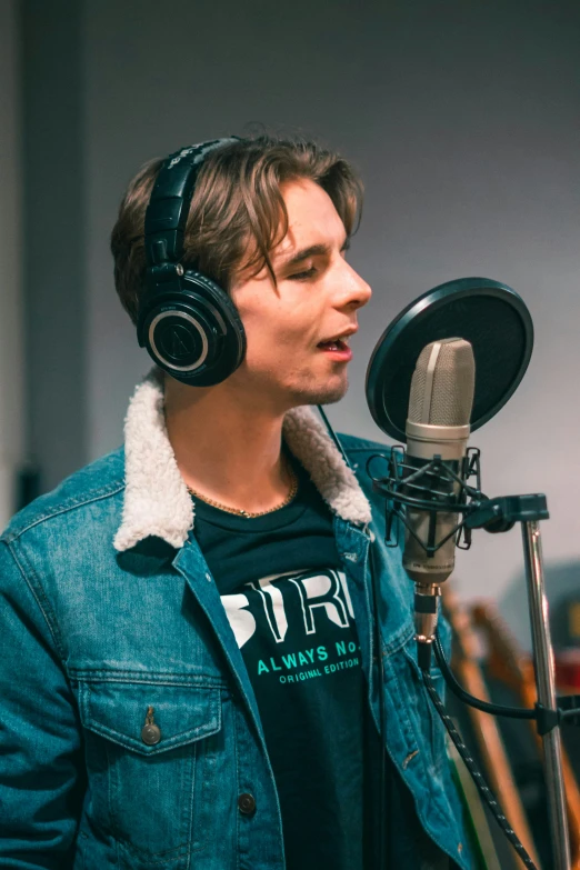 man wearing headphones and singing into a microphone