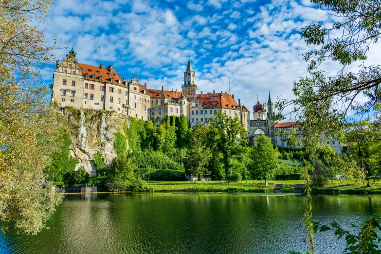 a beautiful castle surrounded by lush greenery on the water