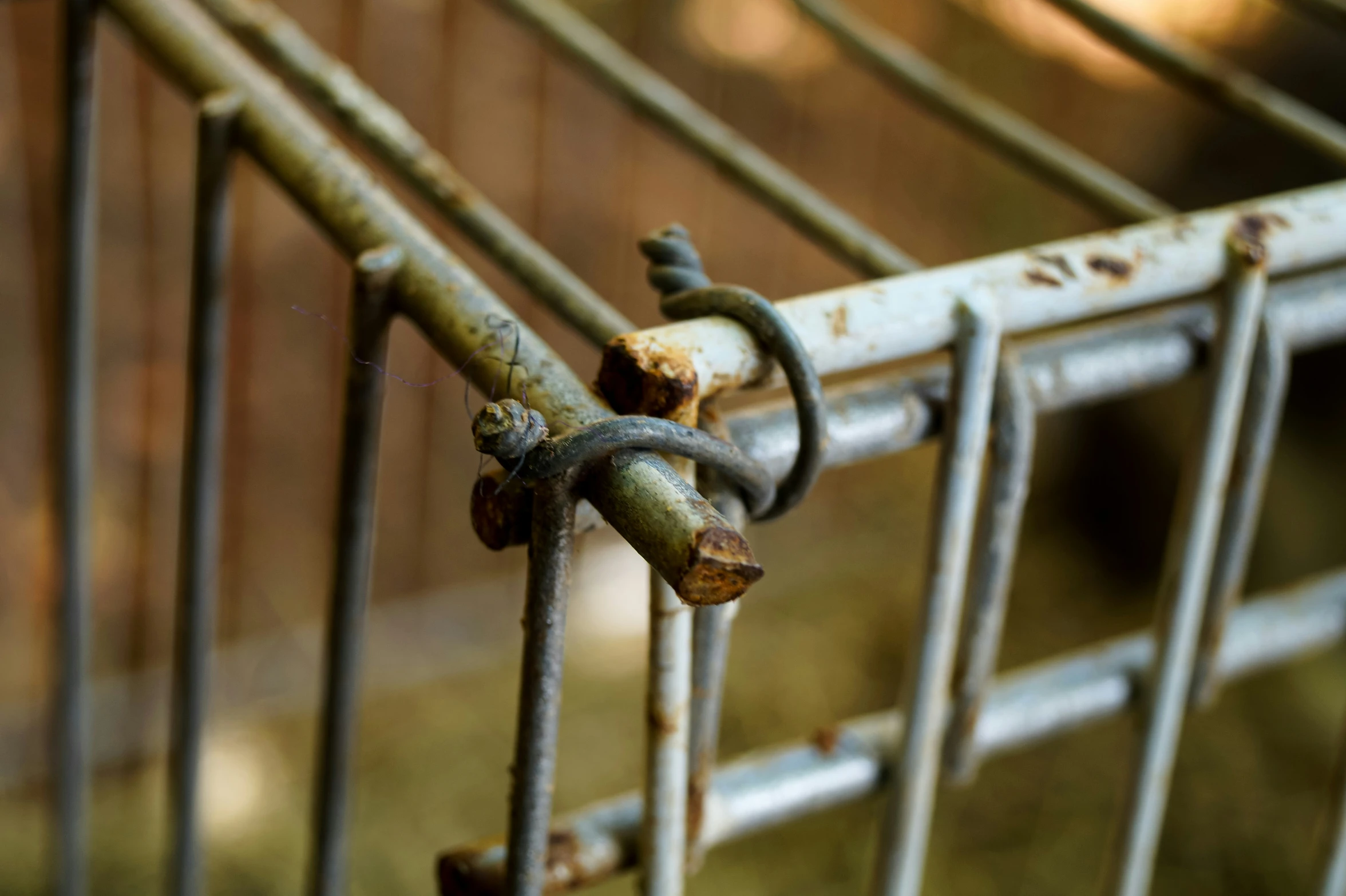 rusty metal railing with rivets and holes on the top