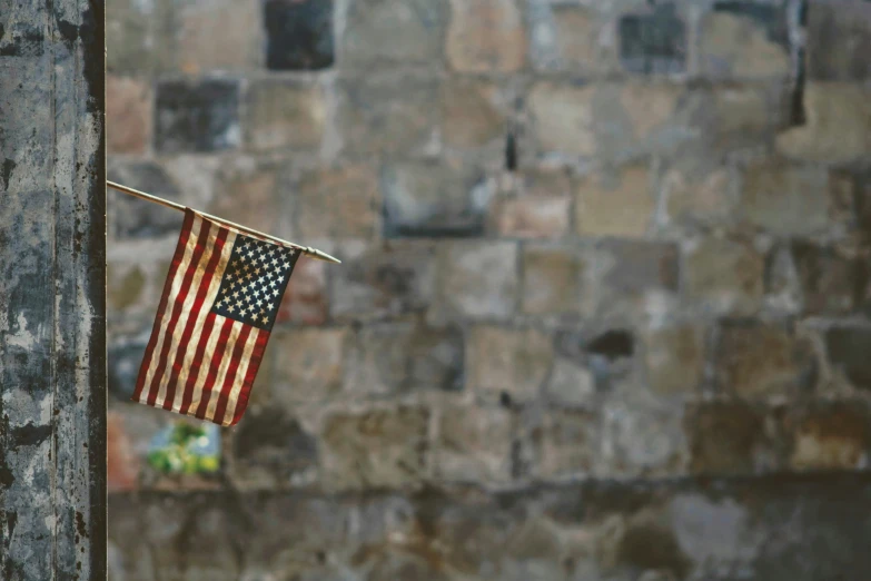 a small american flag is hanging on a rope