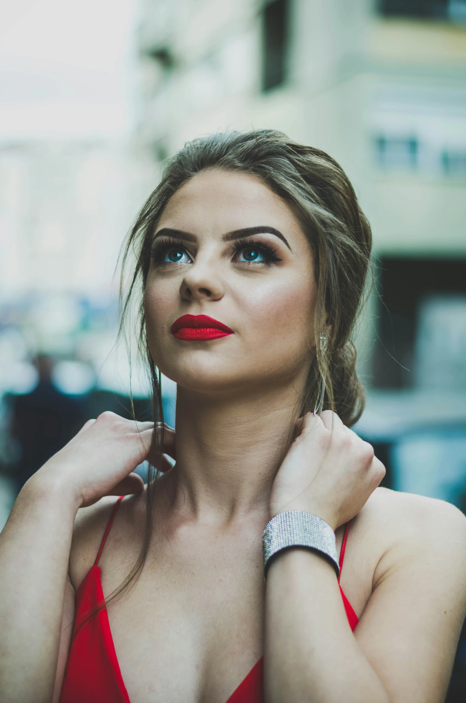 a beautiful woman with red lipstick wearing a celet