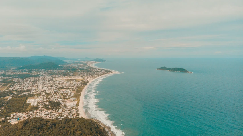 an aerial view of the beach, city and water