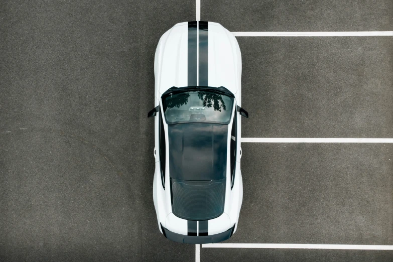 an overhead s of a white sports car in the parking lot