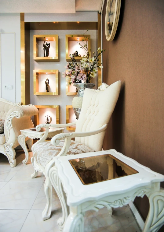 a table and chair with a small glass on it in a room