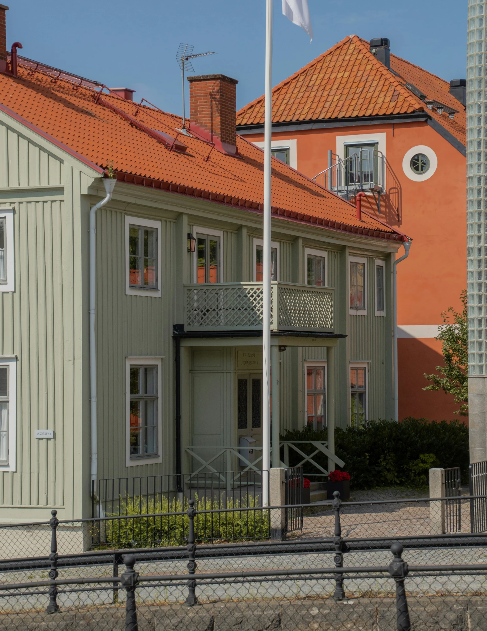 the two buildings are brown and white with a red roof