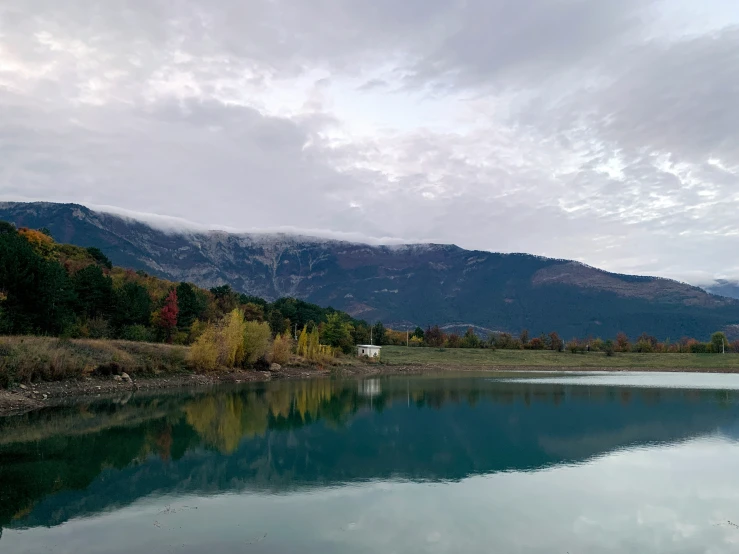 a mountain range sits in the background next to a body of water