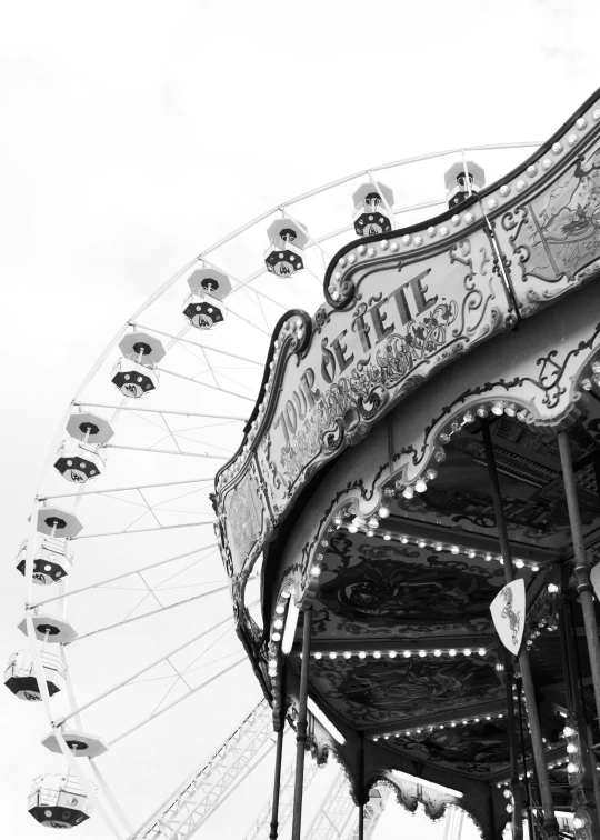 a black and white image of a carnival ride