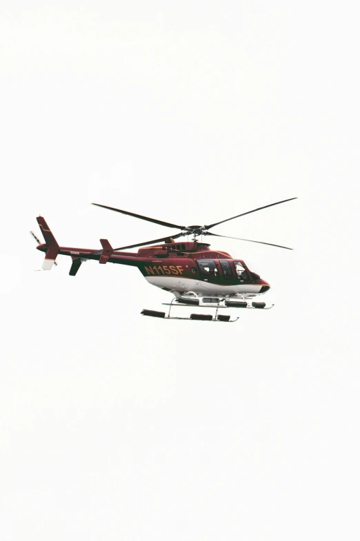 a helicopter flying over the clouds on a sunny day