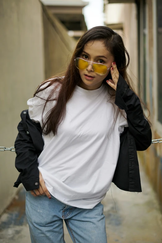 a woman wearing a white shirt, black jacket and sunglasses