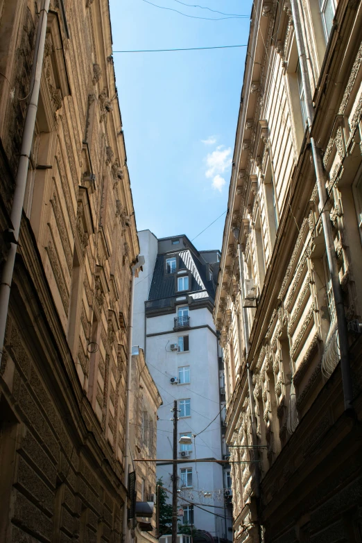 a clock sits on the side of some buildings