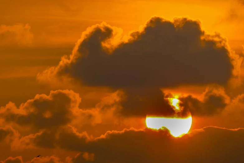 the sun's corona eclipse during a cloud filled sky