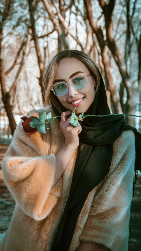 a woman wearing a fur coat and sunglasses holds a rose