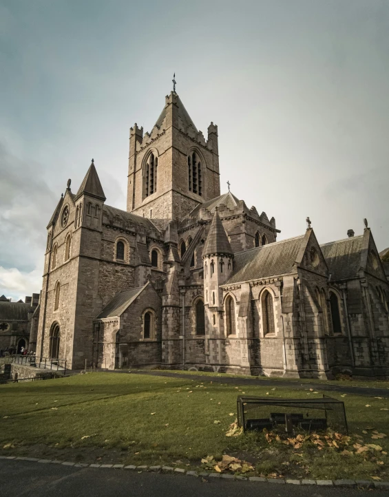 a church with stone front and side towers on a sunny day