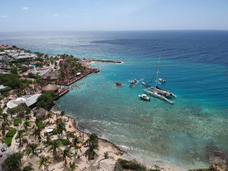 small boats docked next to a sandy shore