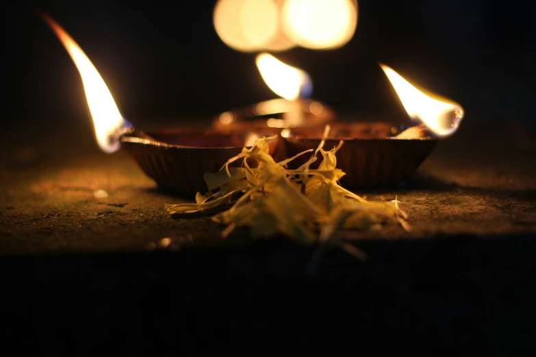 small bowl shaped with three candles sitting on top of a counter