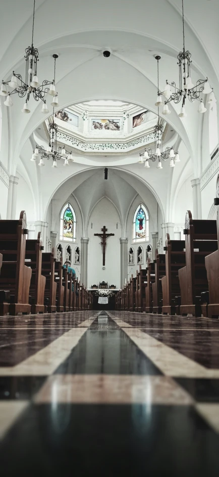 an empty church with pews and chandeliers