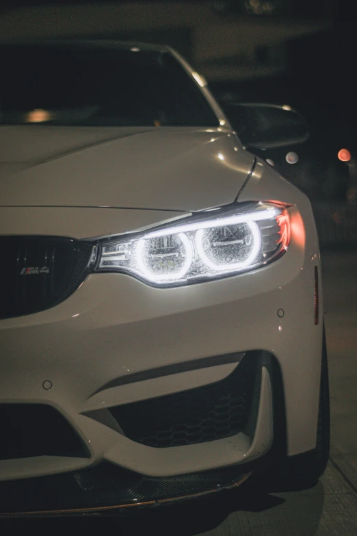 a car's front light is pictured with its bright, ke lights