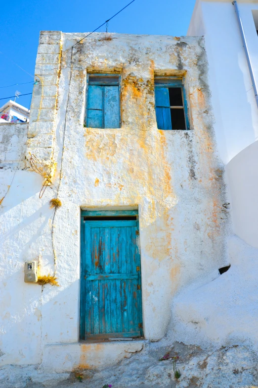 there is a small building with three blue doors