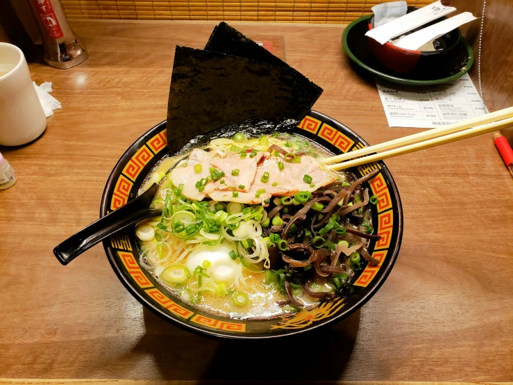 a wooden table topped with a bowl of food