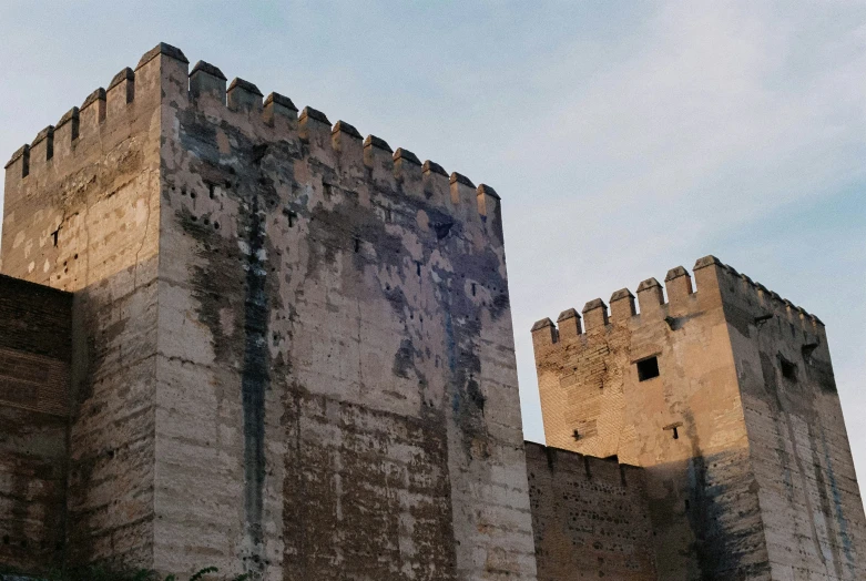 an ancient castle has a broken window and walls