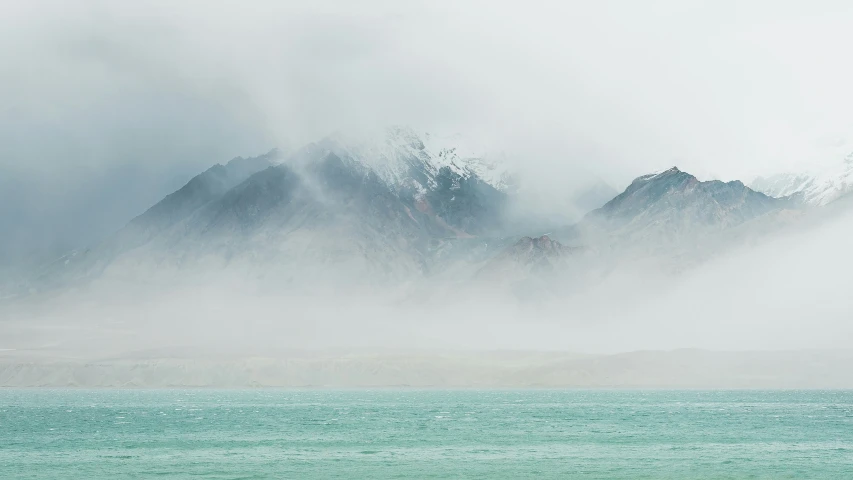 some fog rising off the mountains in the water