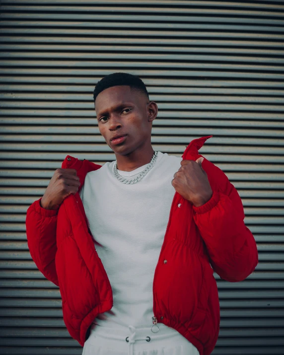 a man wearing a red jacket holding his red jacket