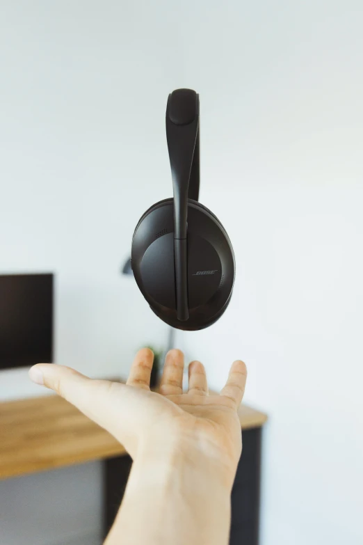 a hand pointing to an object from the ceiling