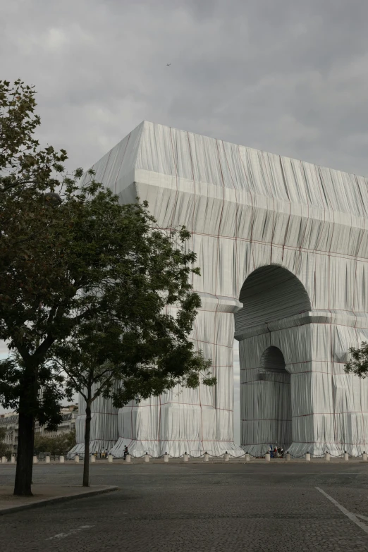 a very big white building with a very tall fence