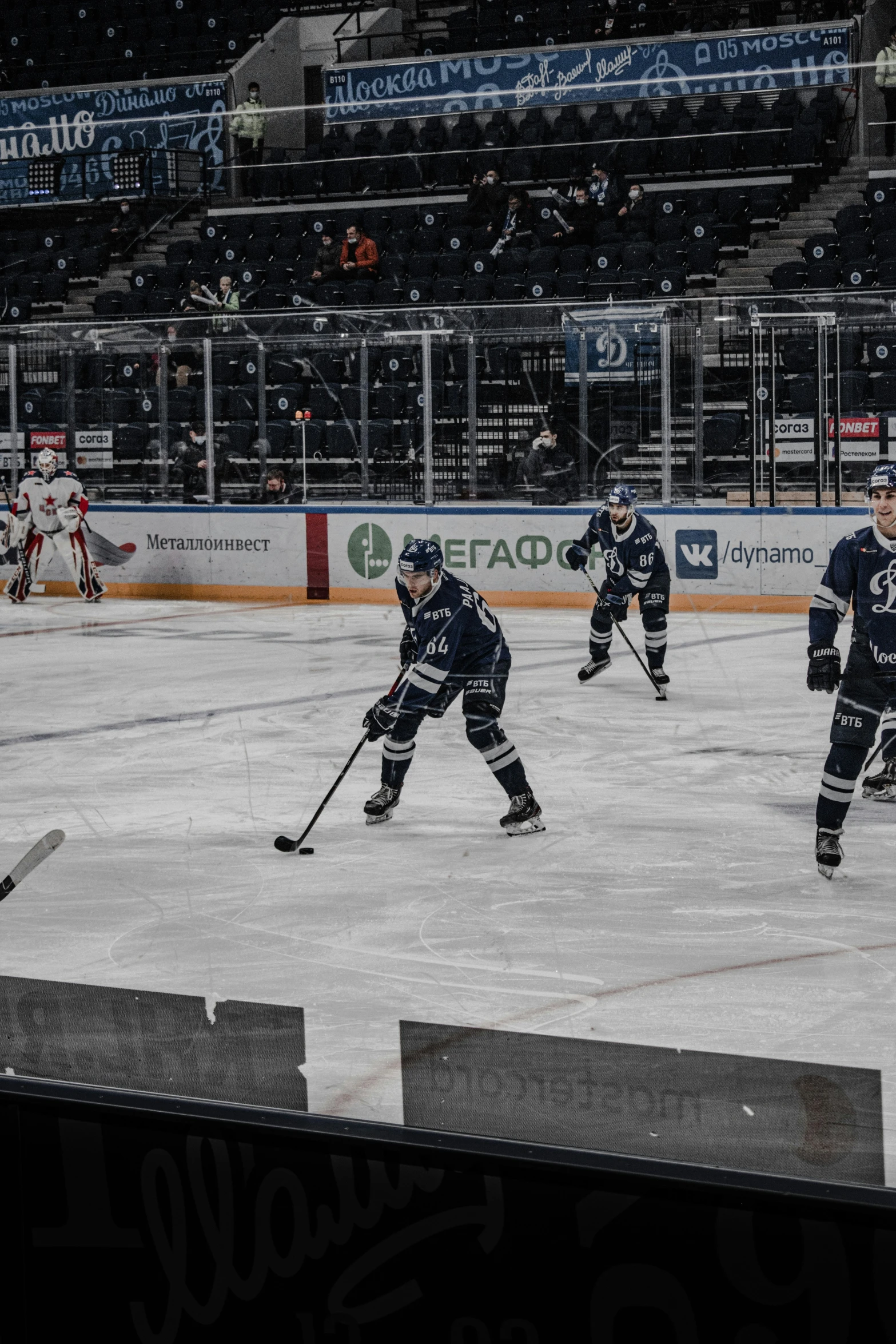 several hockey players in uniform playing on the ice