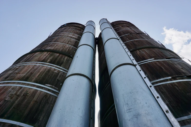 two tall steel stacks towering above a blue sky