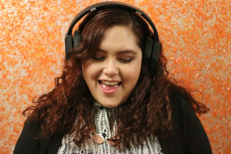 a woman with long brown hair wearing headphones