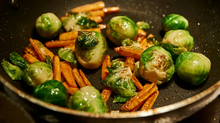 a pan filled with carrots, broccoli and sweet potatoes